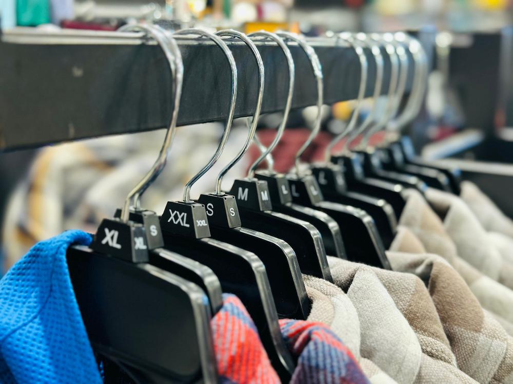 Plastic hangers holding garments.