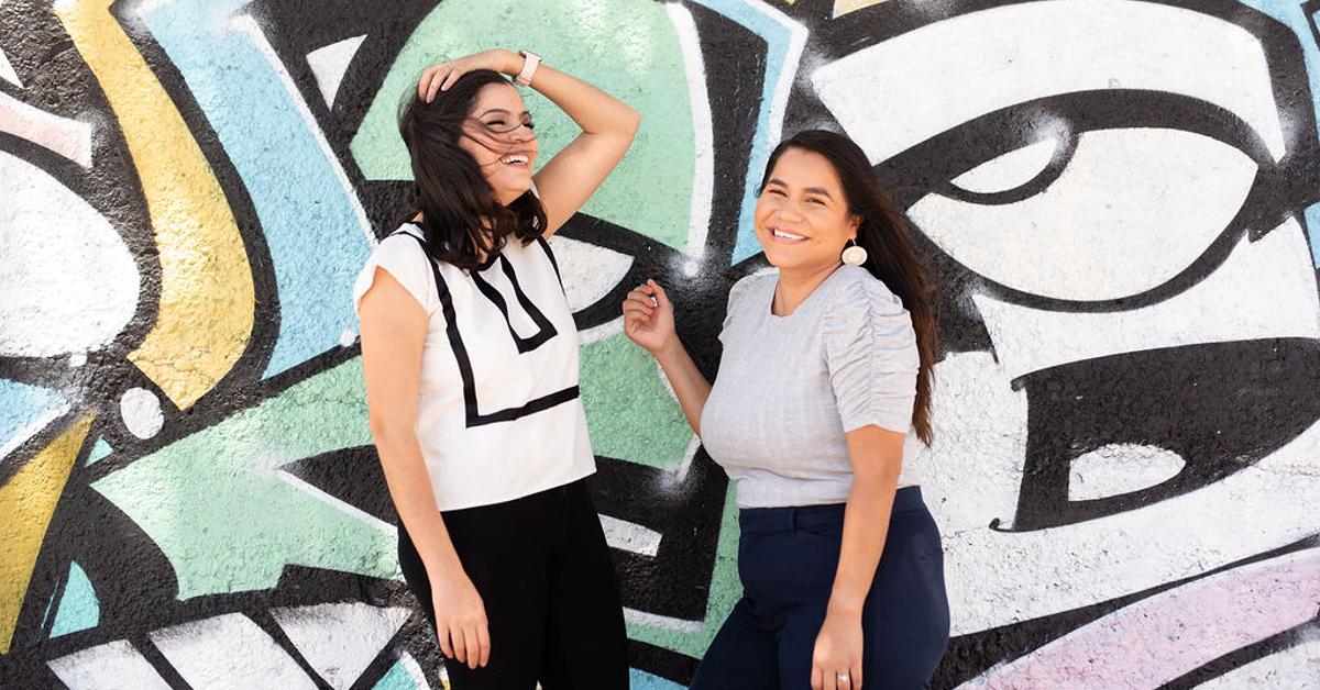 VOLVERde co-founders Aidee and Mónica SanMiguel stand in front of a graffiti wall