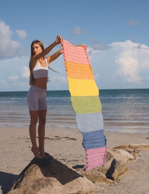 Woman spreading out an Oko Living eco friendly yoga mat