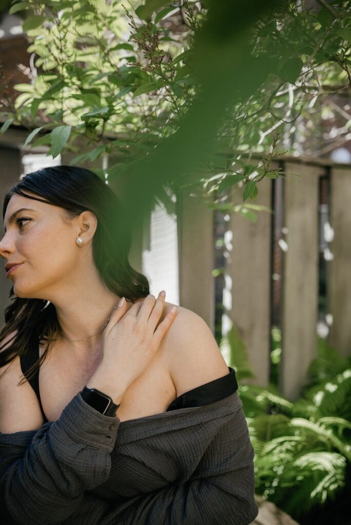 Woman massaging Tiger Balm ointment into her shoulder