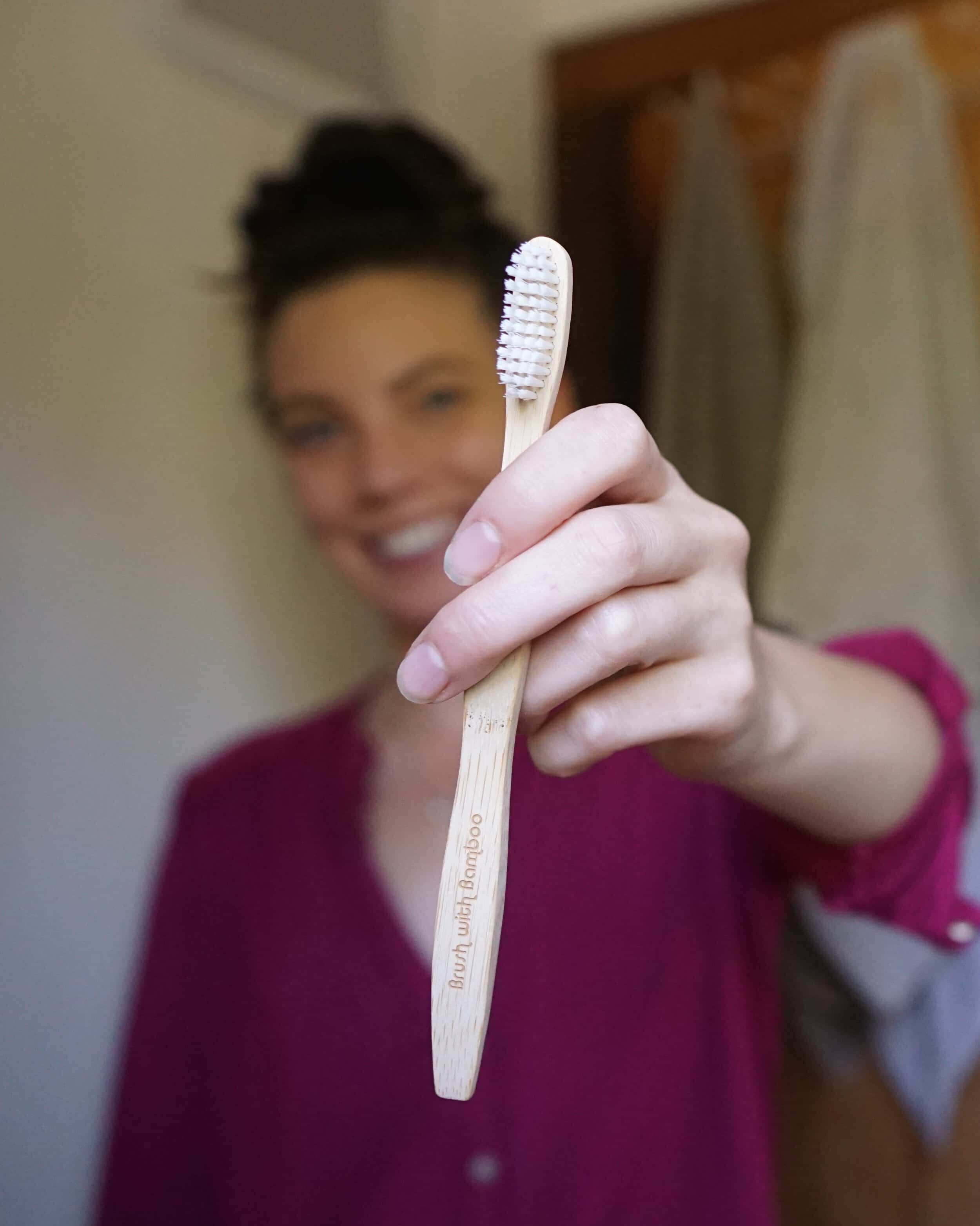 woman holding toothbrush