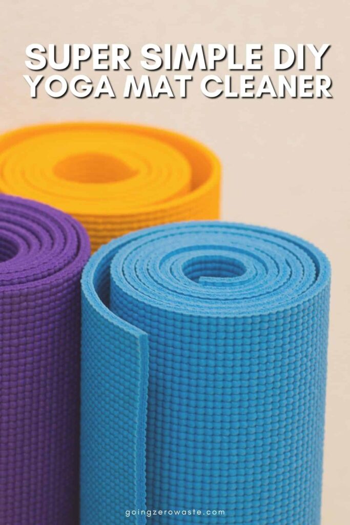 Photo of yoga mats with overlay text reading "Super Simple DIY Yoga Mat Cleaner" in a post about how to clean a yoga mat the eco friendly way.